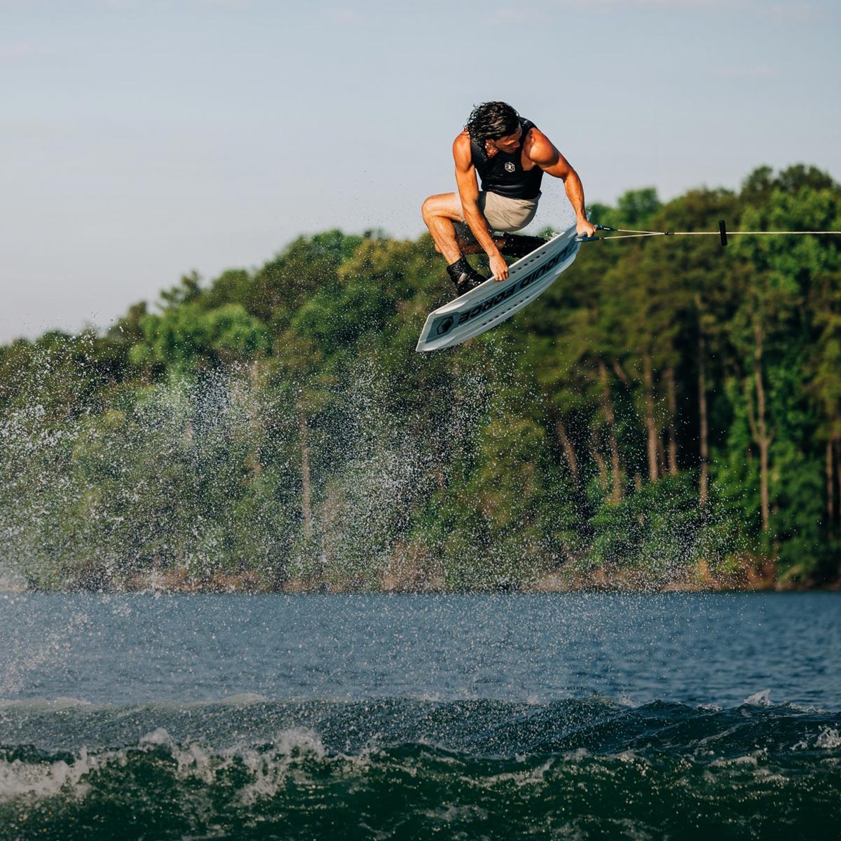 Liquid Force Boat Wakeboard Collection - Closeup shot of LF Athlete Fynn Bullock grabbing his wakeboard in the air.